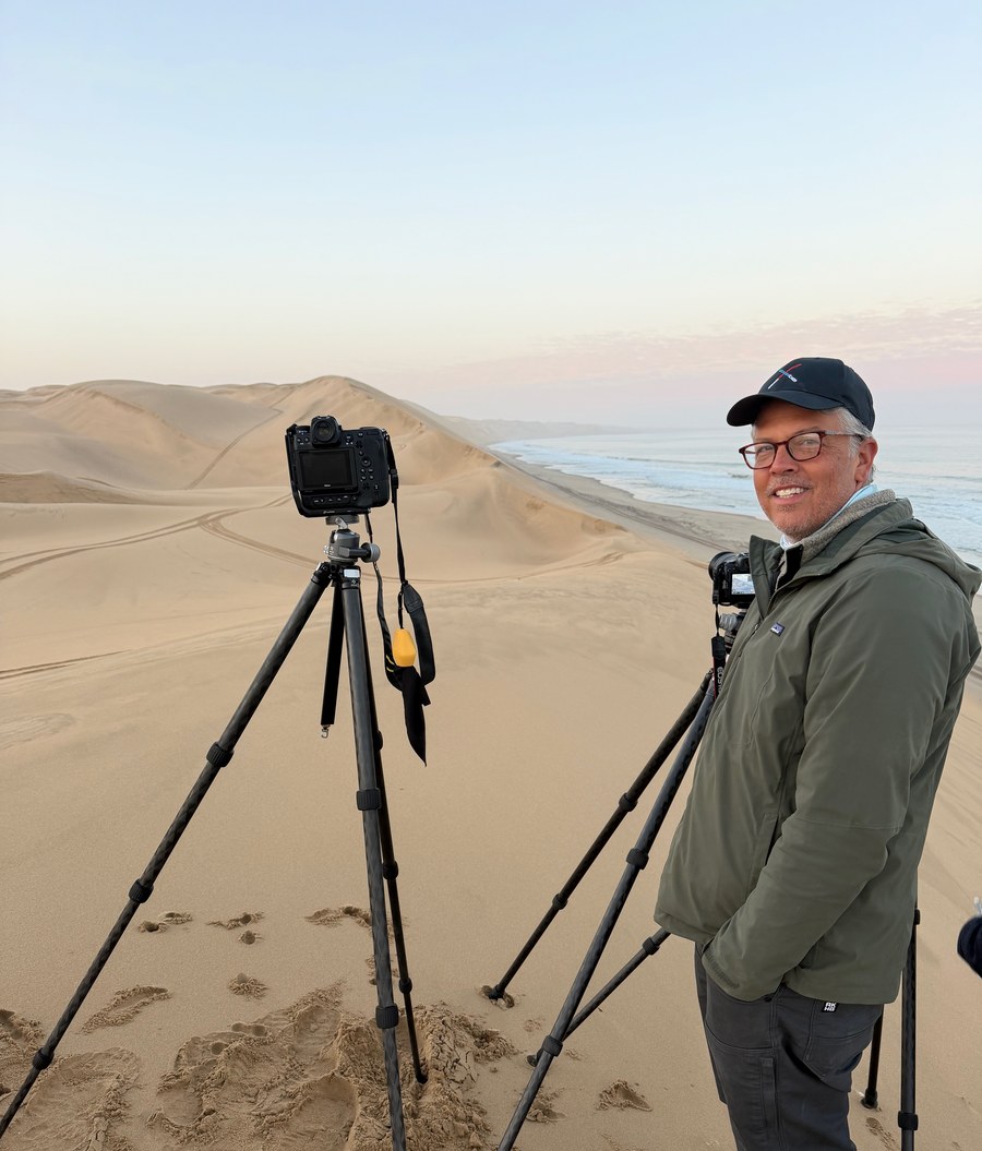 Dr. Douglas Sandquist photographing sand dunes at sunset in Namibia