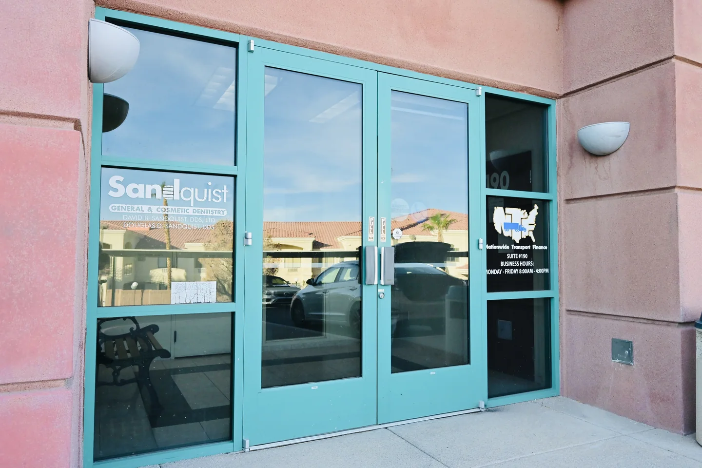 The green double doors at the entrance to Sandquist Dentistry