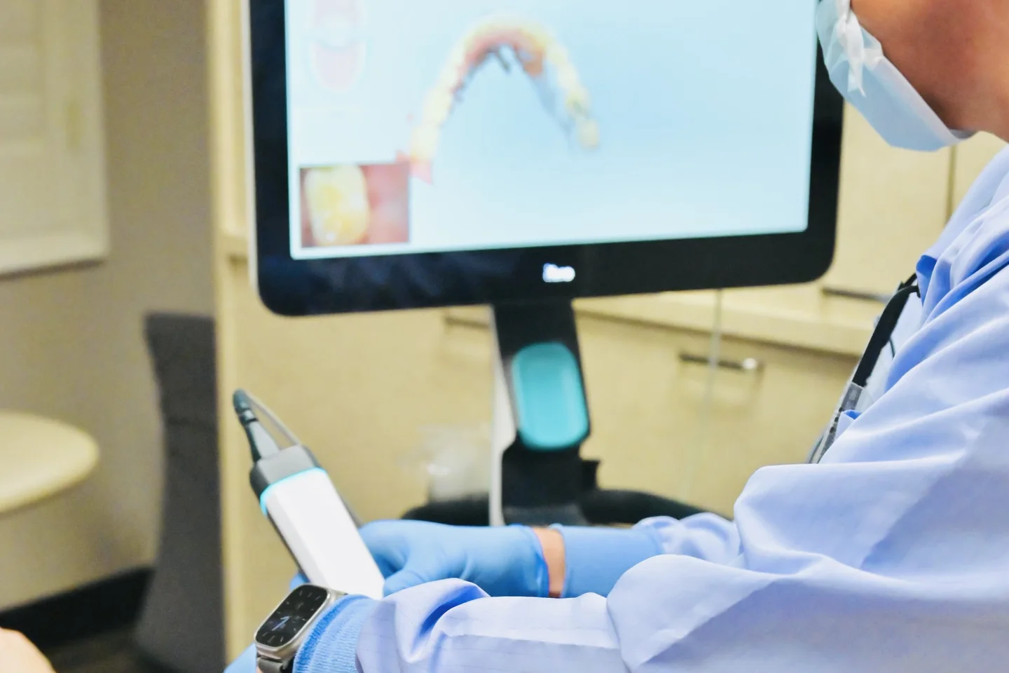 Dr. Sandquist taking a 3D scan of a patient's teeth with a handheld intraoral scanner